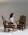 This pair of 19th century Louis XIII upholstered throne armchairs from France, made in dark wood with high backs, scrolled...