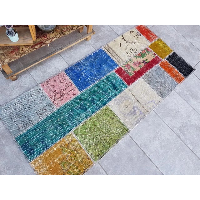 This is a vintage Turkish Oushak rug from the Mid 20th Century. The piece was hand-knotted.