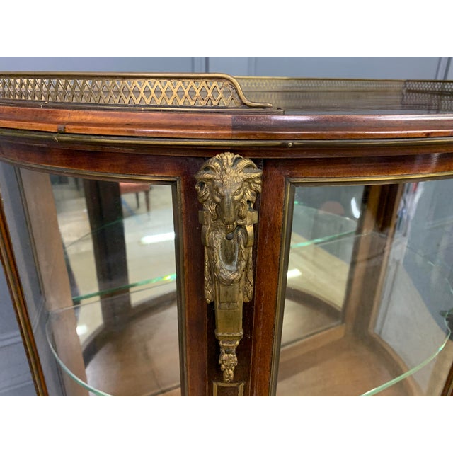 A highly desirable late 19th century French mahogany vitrine. Of demi lune, or bow fronted, form. Of very good...