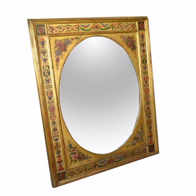 19th century giltwood Italian wall mirror with polychrome grotesque decorations as flowers, birds and lion. This mirror is...