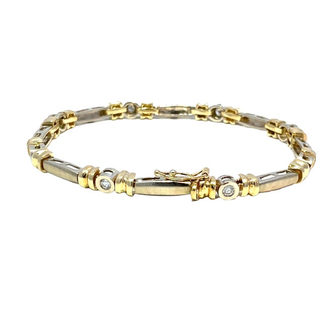 Elevate your jewelry collection with this exquisite estate diamond bracelet, crafted from luxurious 14k yellow and white...