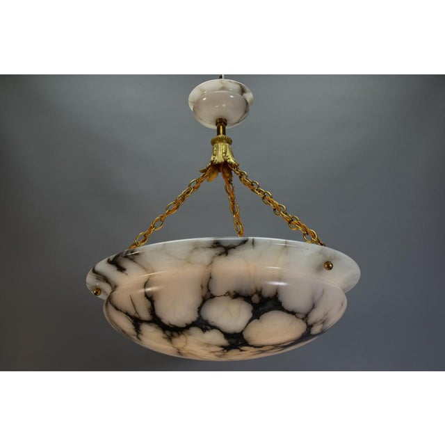 Large-scale french art deco alabaster pendant with dramatic black veining and bronze details a striking french art deco...
