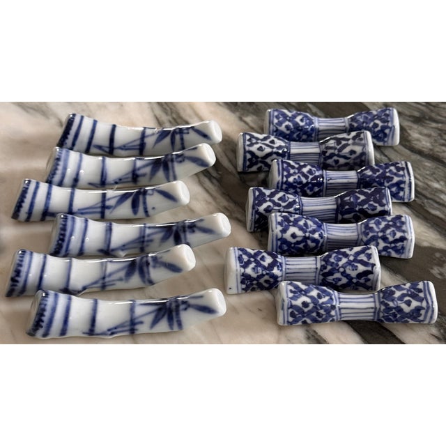 Val's Dollhouse presents a set of 12 + 1 blue and white fine porcelain knife or chop stick rests. In fine mid-century...
