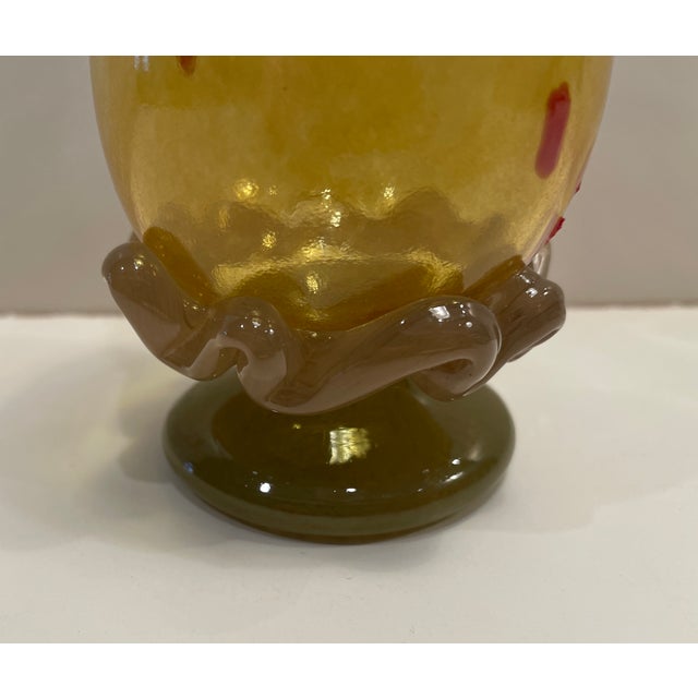 A yellow blown glass goblet. Unsigned several the larger pieces of art glass in this group are signed "Arien" or "AC" and...