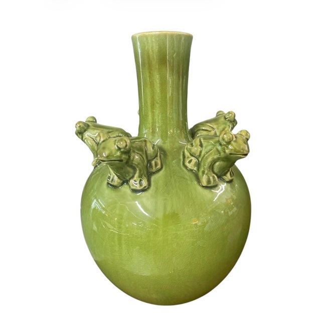 This vintage-inspired Italian ceramic vase features a vibrant pistachio-green glaze with a subtle crackle finish, adding...