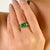 This floral cluster ring featuring 9 marquise & round cut emerald totaling 3 carats, set in 14k yellow gold. The center...