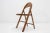 This vintage folding chair was manufactured by Thonet in the 1930s. Labeled by Maker