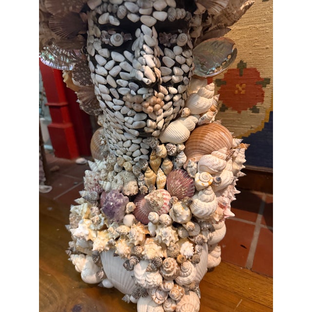 A very large vintage black plaster bust of a classically Inspired male figure xomepletely encrusted in seashells. A fine...