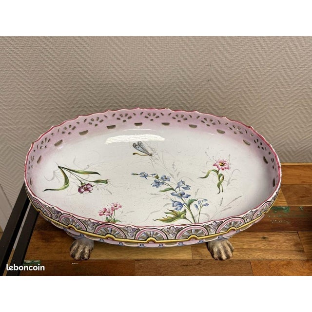 Saint Clement: Large openwork earthenware jardinière, circa 1880-1900 Floral decoration Rests on four animal feet Marked...