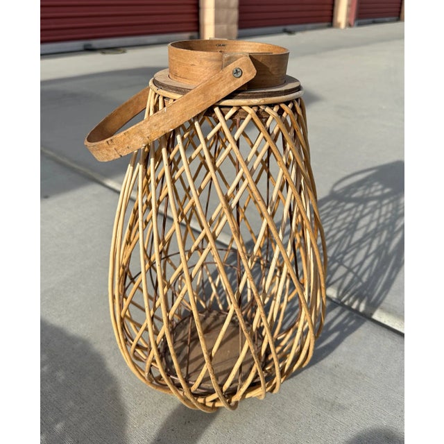 Farmhouse wood/wicker lantern perfect indoors or outdoors on a covered patio or table. 16.5in h to lid 23.5 h to handle...