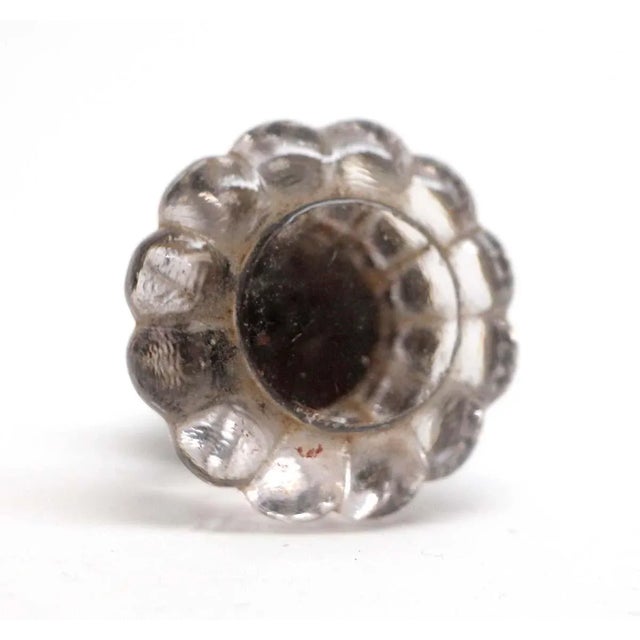 Clear glass flower shaped drawer pull. Good condition with appropriate wear from age. Screw included. One available. The...