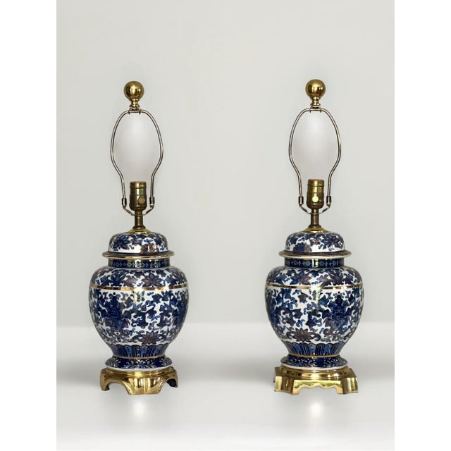 Striking 1980s Chinese bronze mounted blue and white porcelain ginger jar lamps with gilt accents by Speer. Classic...