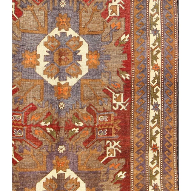 Measures: 7'8'' x 10'3''. This vintage Turkish Oushak gallery rug (circa mid-20th century) features a unique blend of...