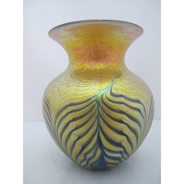 Lundberg Studios, California hand blown glass vase. Features an intricate glass-blowing technique that create a...