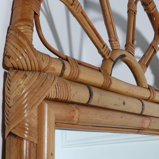 1960’s bamboo and rattan wrapped wall mirror with arched sunburst detailing. After Franco Albini. 26”W x 2” D x 54”H