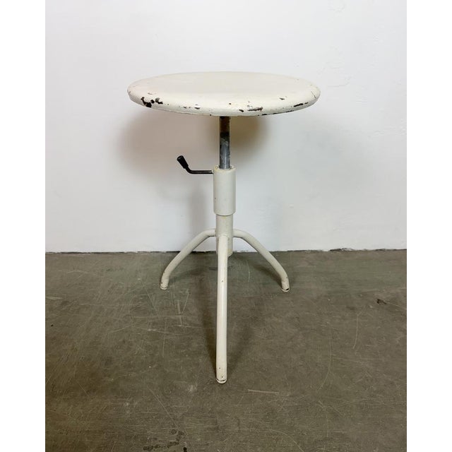 Industrial iron three-legged height adjustable medical stool made in former Czechoslovakia during the 1960s. Min.- Max....