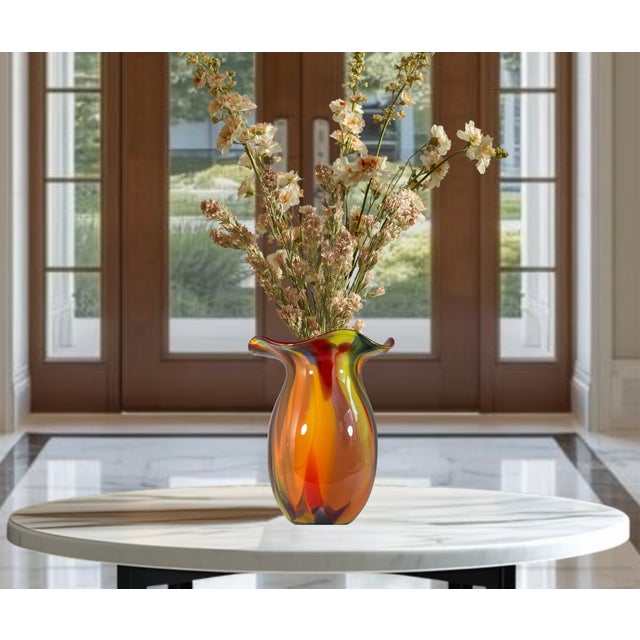Standing an impressive 12 1/2 inches tall, this striking hand-blown art glass vase showcases a bold freeform silhouette...