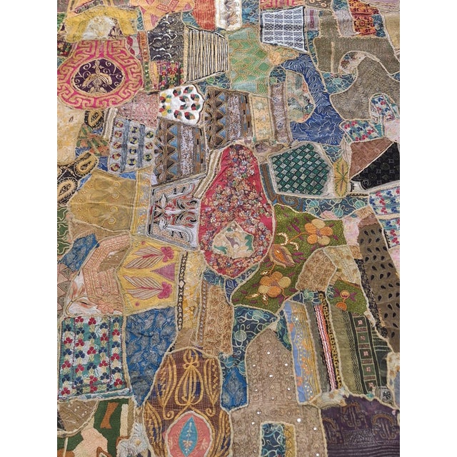 Large-scale hand-embroidered patchwork textile composed of dozens of antique embroidered fragments, thoughtfully appliquéd...
