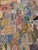 Large-scale hand-embroidered patchwork textile composed of dozens of antique embroidered fragments, thoughtfully appliquéd...