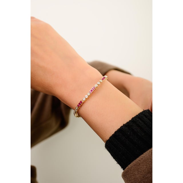 This elegant tennis bracelet features square cut rubies 3.42 carats, set in rich 14k yellow gold. Each vibrant ruby...