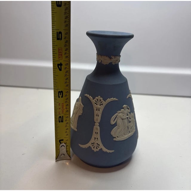 Bring timeless neoclassical beauty into your home with this vintage Wedgwood Blue Jasperware bud vase. this elegant piece...