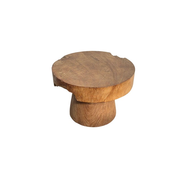 Handcrafted from reclaimed solid teak wood, this sculptural side table showcases the raw beauty and enduring character of...