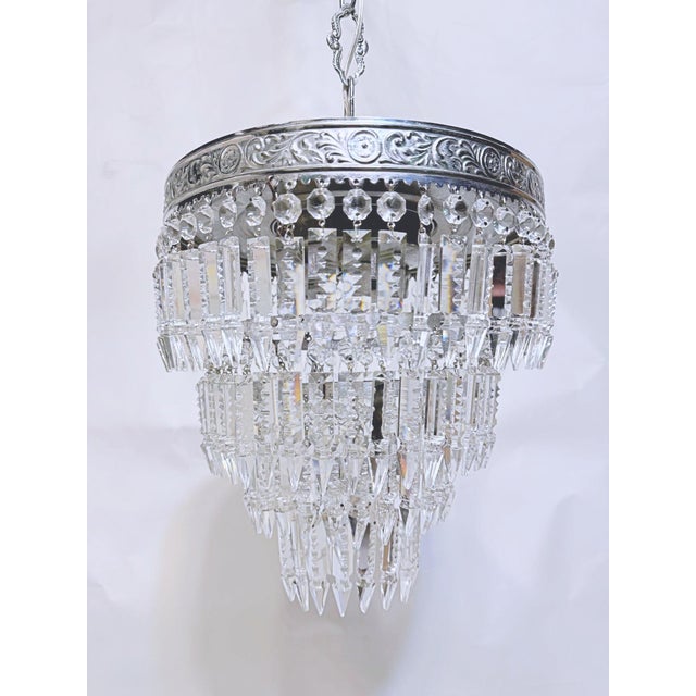 Italian layered chandelier with decorative Silver rim, octagon beads and hand cut spear drops. It has 3 layers of crystals...