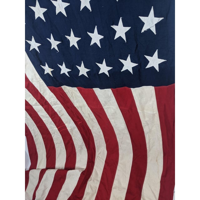 An impressive large-scale vintage American flag by Valley Forge featuring the historic 48-star configuration used before...