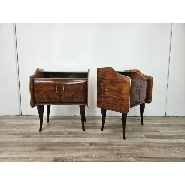 These 1950s-style bedside tables exude an elegant and timeless charm, crafted from walnut burl that highlights the natural...