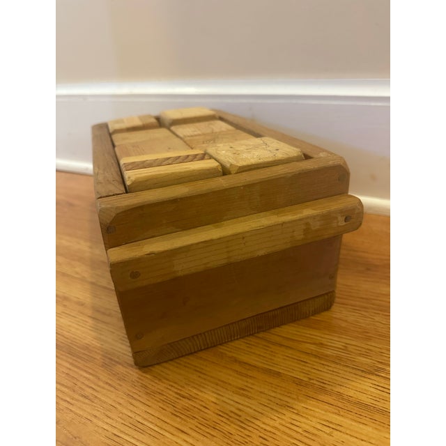 A nostalgic set of vintage wooden building 16 blocks accompanied by a simple handcrafted wooden storage box. The blocks...