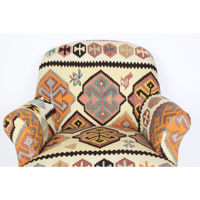 Add warmth and character to your space with this beautifully handcrafted armchair, upholstered in a vintage Turkish kilim....