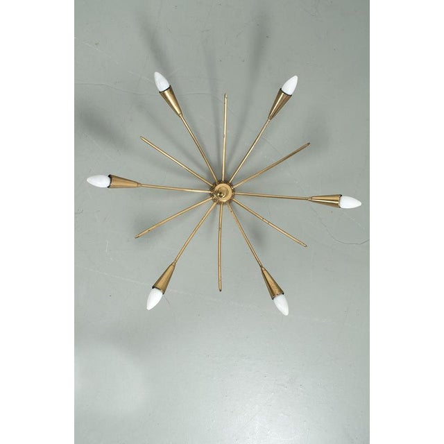 Sputnik ceiling lamp from the 50s; made of brass. The brass has patina consistent with the age of the lamp. Furthermore in...