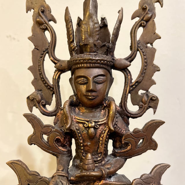 "An exquisite example of traditional Dhokra (lost-wax) casting, this vintage bronze sculpture depicts Surya, the Hindu Sun...