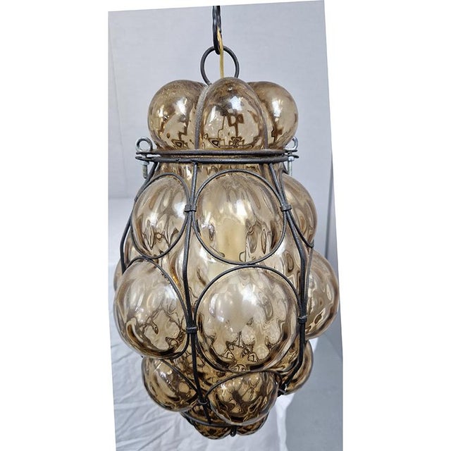 Vintage Italian pendant lamp in hand-blown Murano glass in a wrought iron structure. Dimensions (l x h) 14 x 67 cm. Up to...
