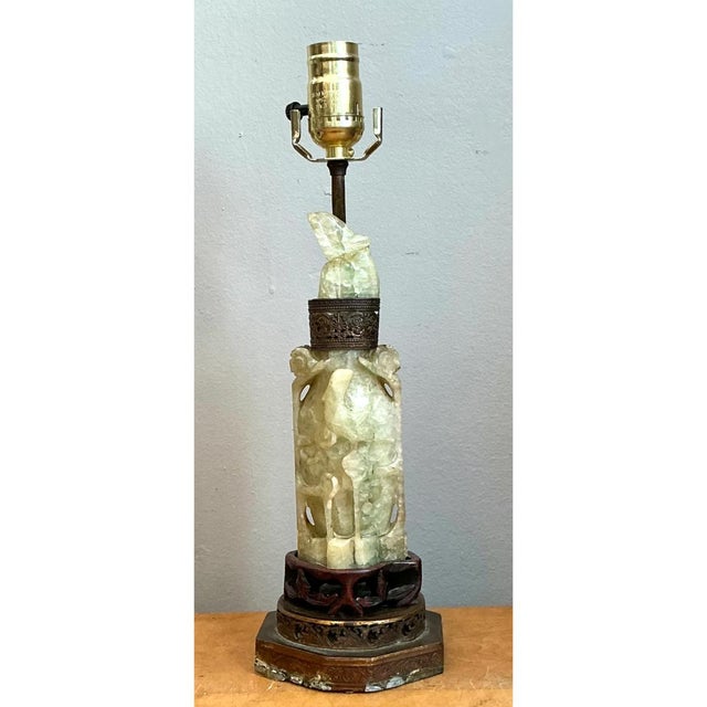 This vintage table lamp centers on a hand-carved column of pale green jadite, its cylindrical form pierced and sculpted...