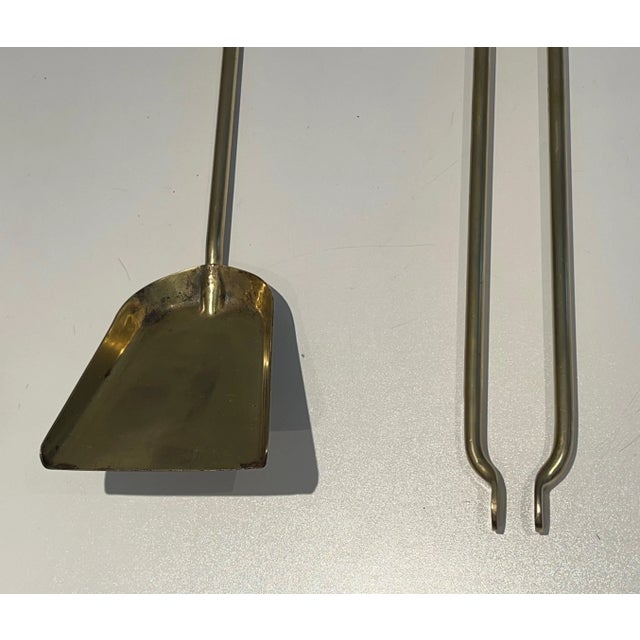 This design fireplace tools are made of brass on a glass stand with brass feet. This is a French work. Circa 1970.