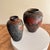 A pair of Japonesque hand painted lacquerware vases with botanical, butterfly and bird motifs and a bark impression into...
