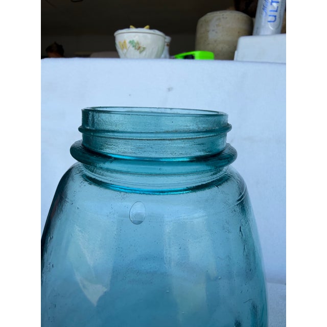 Beautiful, antique ( dated from logo archives 1920- 1923 ) aqua blu Ball mason jars. Featuring the classic lid associated...