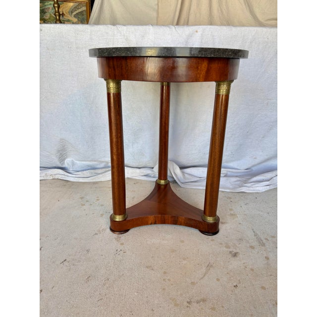 Found in the South of France, this Early 20th Century French Walnut Empire Style Side Table dates back to the early...