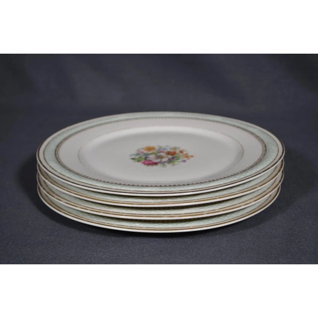 France, Raynaud Limoges, 1960s. Set of 4 porcelain plates, Diameter 9.8 in, height 0.8 in. The edge has a very light green...