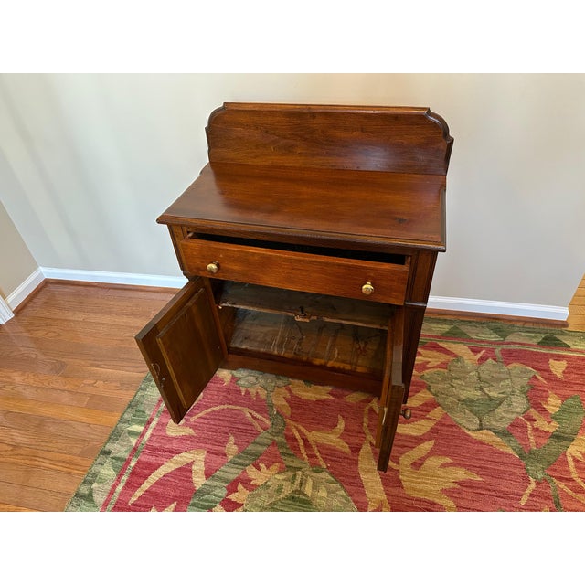 Antique wash stand with backsplash, one drawer and lower doors. Some wear indications as of it's age