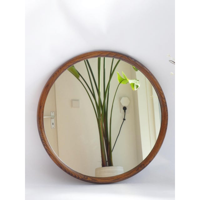 A vintage original wooden mirror in round shape. The wall mirror is made in the Netherlands in the 60's and still has its...