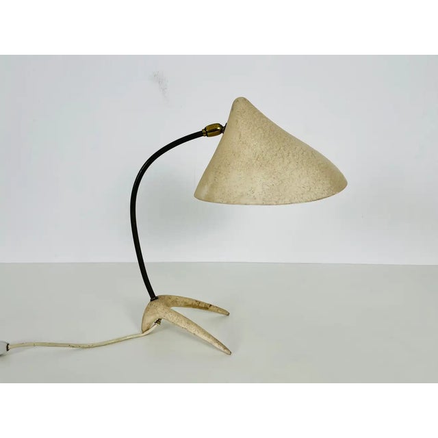 Exceptional mid-century table lamp designed by Louis Kalff for Cosack in the 1950s. Its crow foot is typical for the...