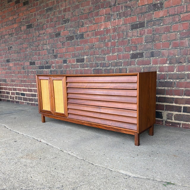 A beautifully designed Mid-Century Modern credenza from the Wonderwood collection by American of Martinsville. This line...