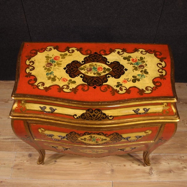 Small tuscan dresser from the mid-20th century. A curved and rounded piece of furniture, richly lacquered, gilded and...