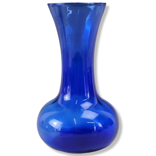 This is a stunning cobalt blue glass vase made by Indiana Glass. The vase features an "Illusions" pattern, a light swirl...