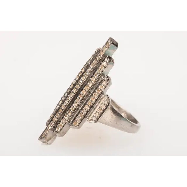 Set in an oxidized sterling silver, an Art Deco style ring with pave`-set diamonds. Diamond weight is .55 carats. Ring...