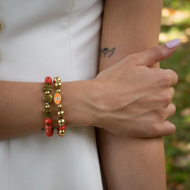 Embrace spiritual energy and bold elegance with the Evil Eye & Shell Symbol Gold Beaded Protection Bracelet Set....