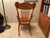 A solid oak rocking chair with pressed design on the front. This chair was purchased 38 years ago from specialty Oak...