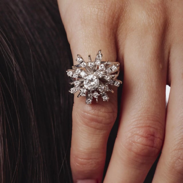 This vintage 1970’s 14k white gold ring shimmers with a central 0.50 carat round brilliant diamond framed by an elegant...